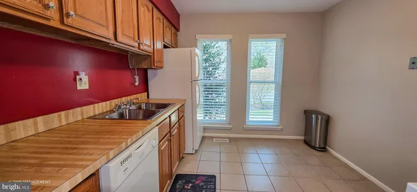 a kitchen with a sink a stove and cabinets