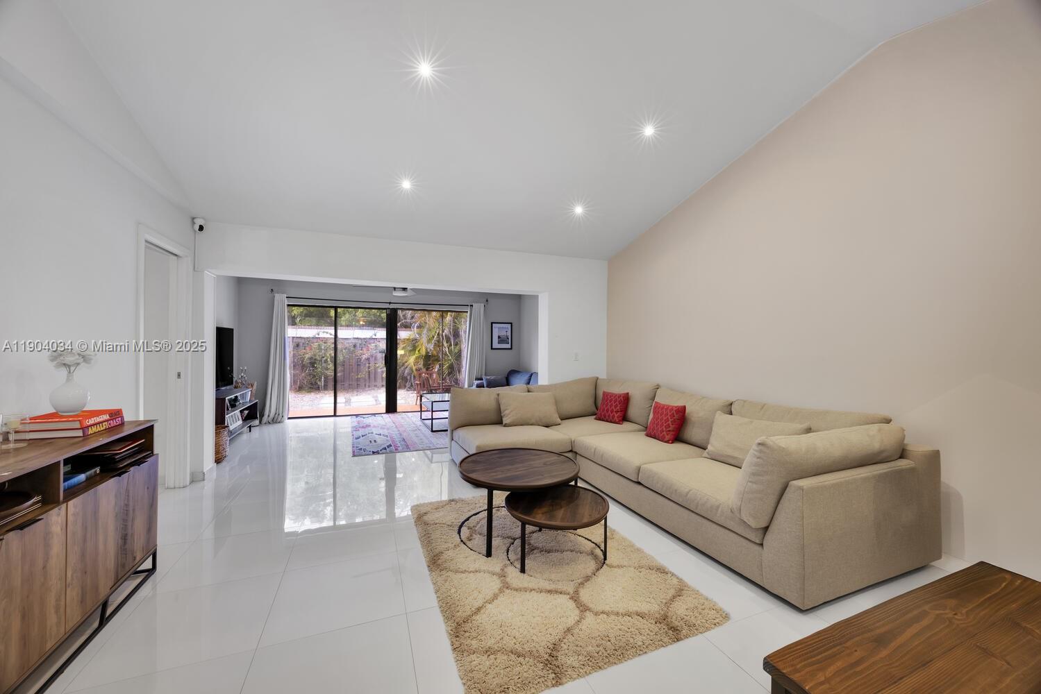 8596 Southwest 115th Place Miami, FL 33173 - Photo 13 of 39 a living room with furniture and a large window