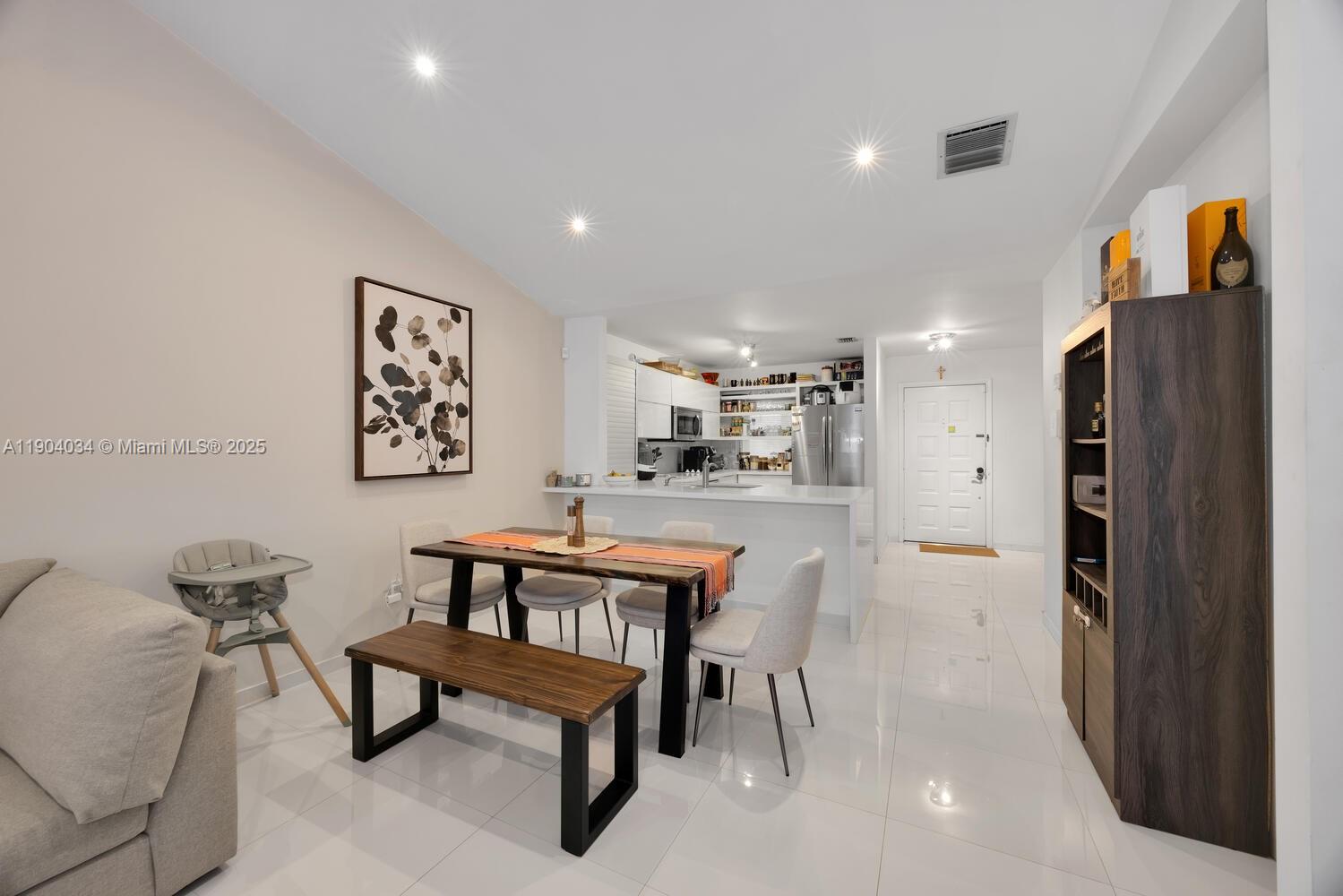 8596 Southwest 115th Place Miami, FL 33173 - Photo 14 of 39 a living room with furniture and a refrigerator