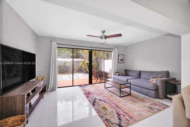 a living room with furniture tv and a flat screen tv