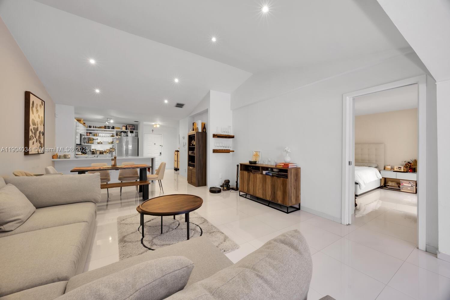 8596 Southwest 115th Place Miami, FL 33173 - Photo 19 of 39 a living room with furniture and a table