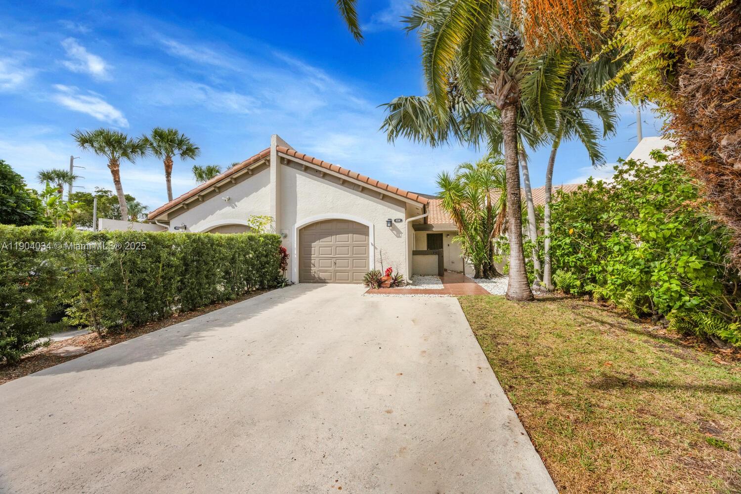 8596 Southwest 115th Place Miami, FL 33173 - Photo 2 of 39 a front view of a house with a garden