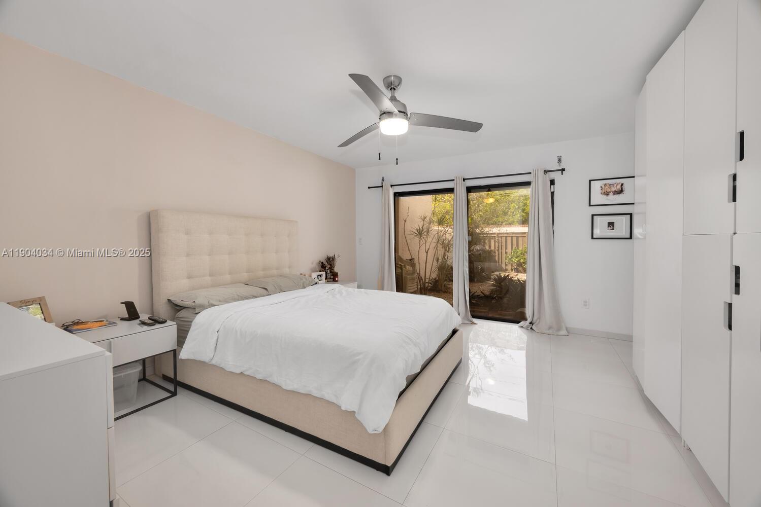 8596 Southwest 115th Place Miami, FL 33173 - Photo 22 of 39 a bedroom with a bed and a window