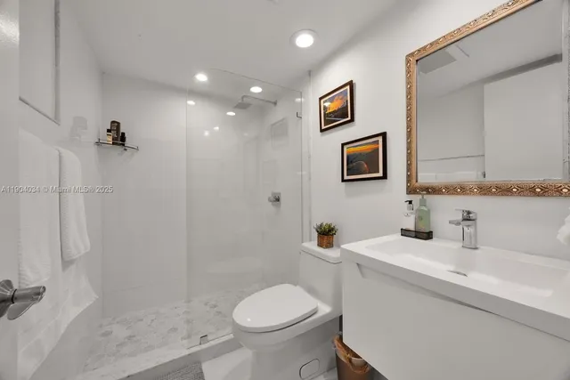 a bathroom with a sink toilet and shower