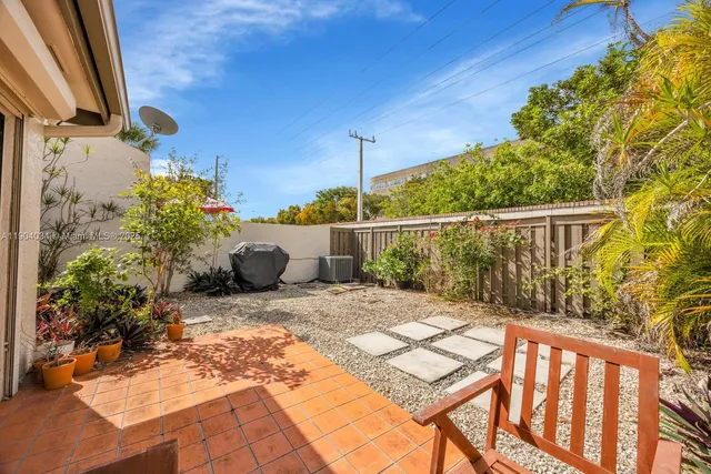 a backyard of a house with a tree