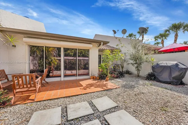 a front view of a house with outdoor seating