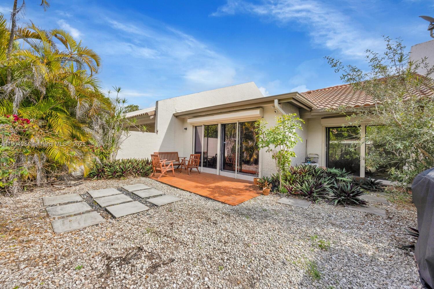 8596 Southwest 115th Place Miami, FL 33173 - Photo 35 of 39 a view of a house with backyard sitting area and garden
