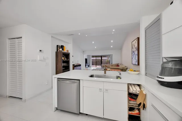 a kitchen with a sink and a refrigerator