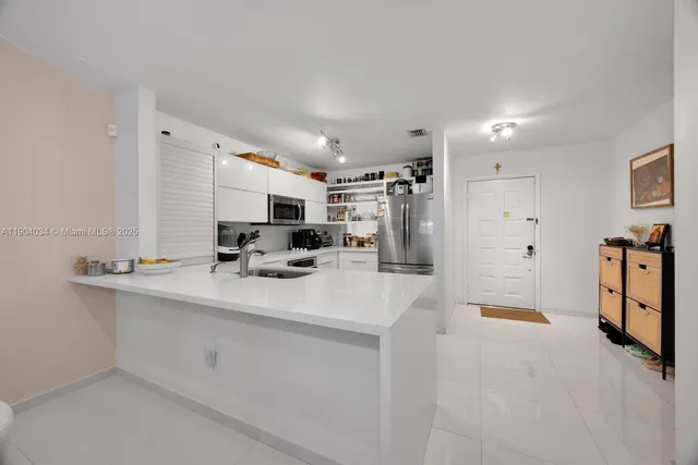 a view of kitchen sink and refrigerator