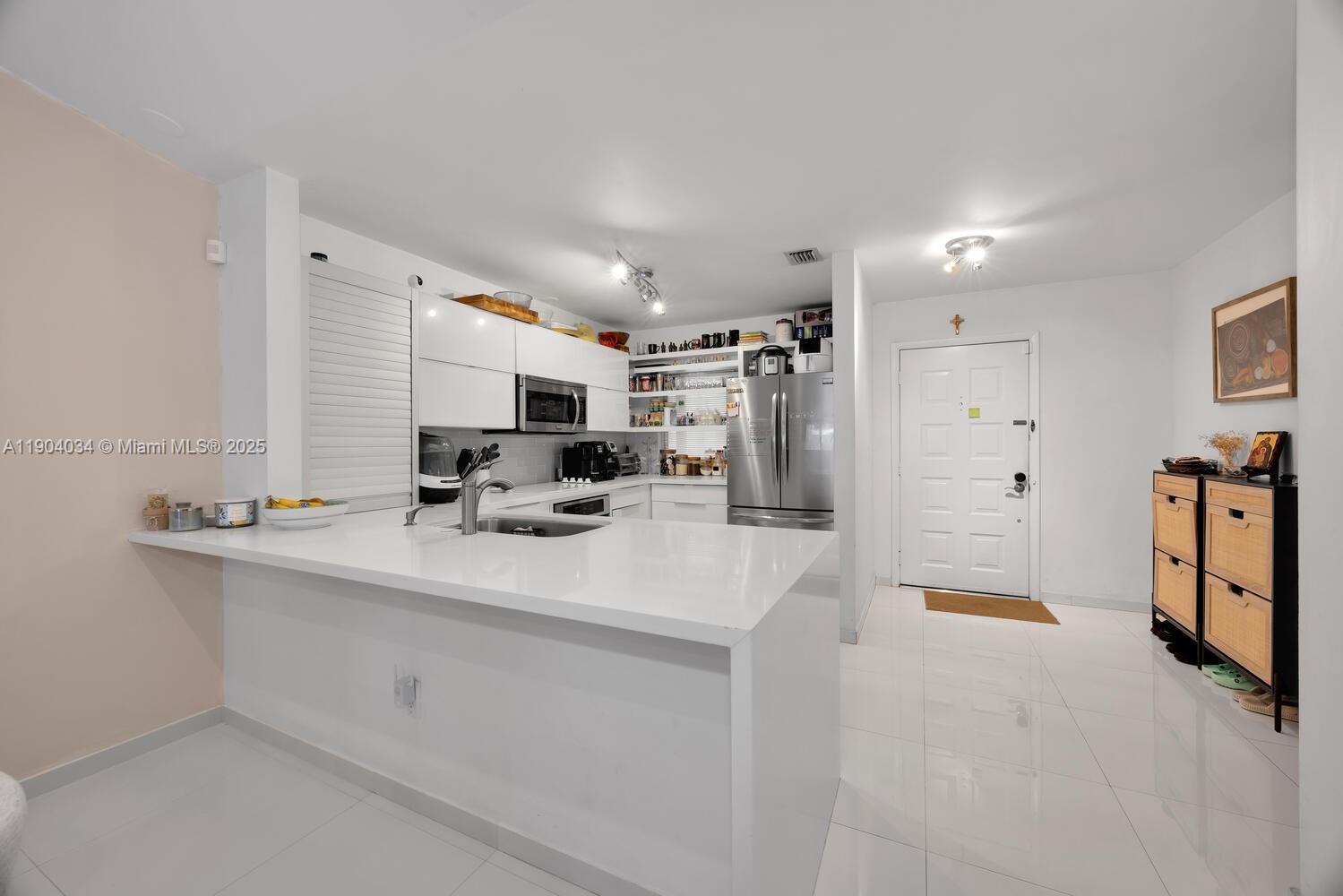 8596 Southwest 115th Place Miami, FL 33173 - Photo 10 of 39 a view of kitchen sink and refrigerator