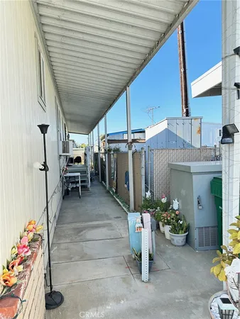 a view of a patio with table and chairs potted plants
