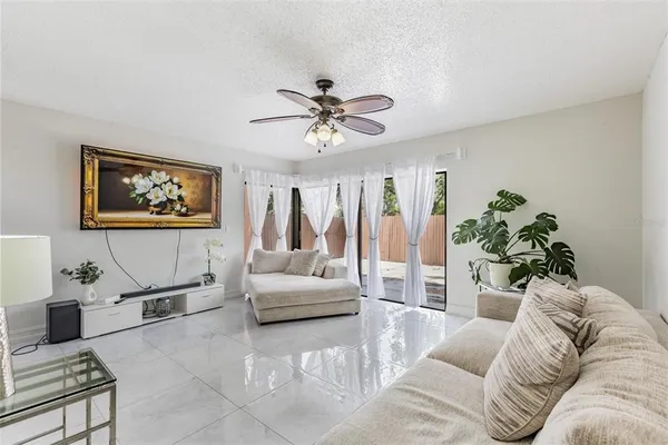 a living room with furniture and a potted plant