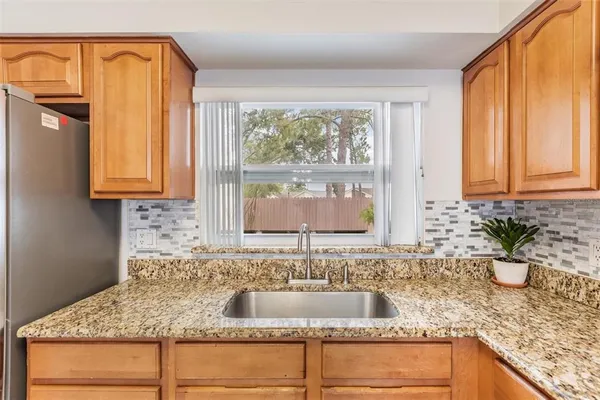 a kitchen with granite countertop a sink and a window