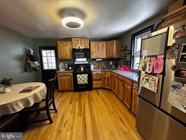 4402 Allegheny Road Manns Choice, PA 15550 - Photo 16 of 25 a kitchen with stainless steel appliances granite countertop a sink stove and wooden cabinets