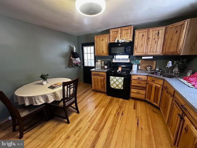 4402 Allegheny Road Manns Choice, PA 15550 - Photo 17 of 25 a kitchen with wooden floors and wooden cabinets
