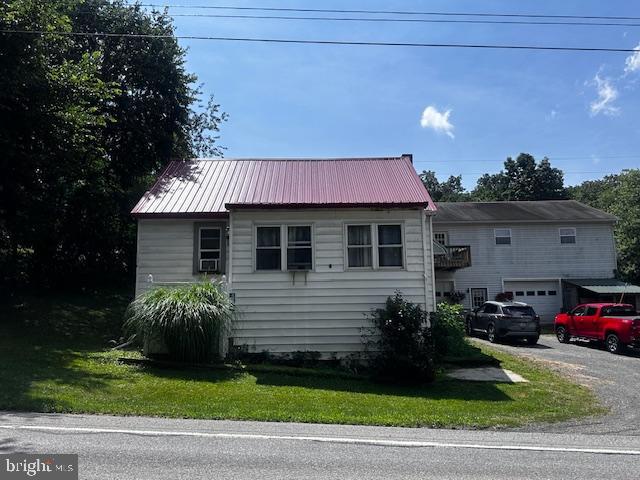 4402 Allegheny Road Manns Choice, PA 15550 - Photo 2 of 25 a front view of a house with a garden and parking
