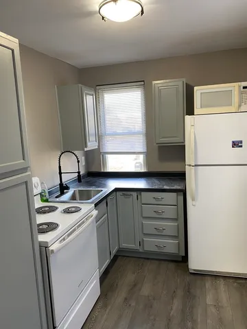 a kitchen with a stove cabinets and a refrigerator