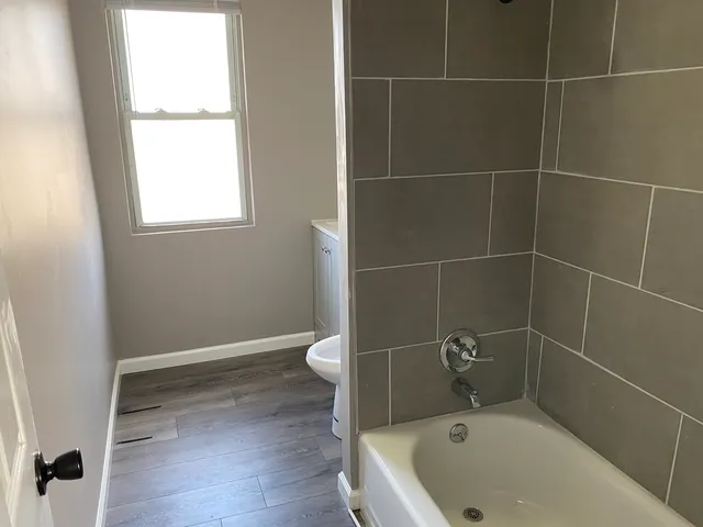 a bathroom with a bathtub and window