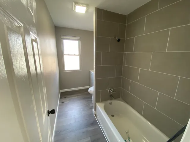 a bathroom with a bathtub and a shower