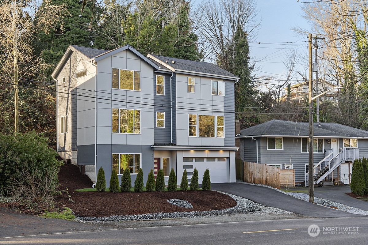 7511 Dumar Way Southwest Seattle, WA 98106 - Photo 1 of 35 a front view of a house with a yard