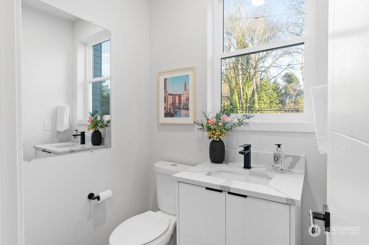 7511 Dumar Way Southwest Seattle, WA 98106 - Photo 11 of 35 a bathroom with a toilet sink and mirror