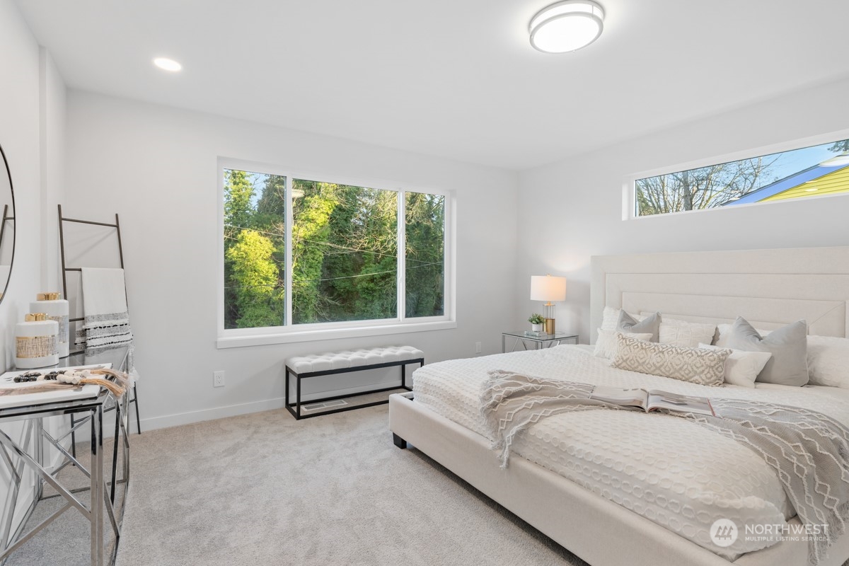 7511 Dumar Way Southwest Seattle, WA 98106 - Photo 15 of 35 a bedroom with a bed and a large window