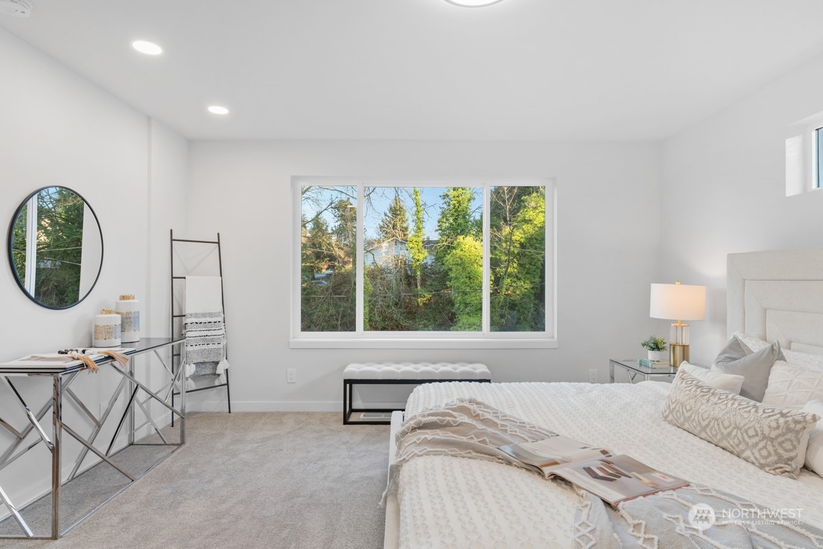 7511 Dumar Way Southwest Seattle, WA 98106 - Photo 16 of 35 a bedroom with a bed a mirror and a large window