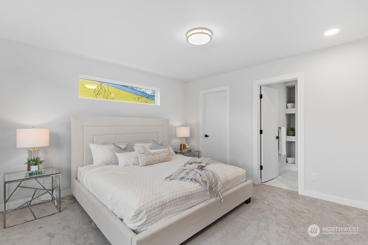 7511 Dumar Way Southwest Seattle, WA 98106 - Photo 17 of 35 a bedroom with a bed and lamps