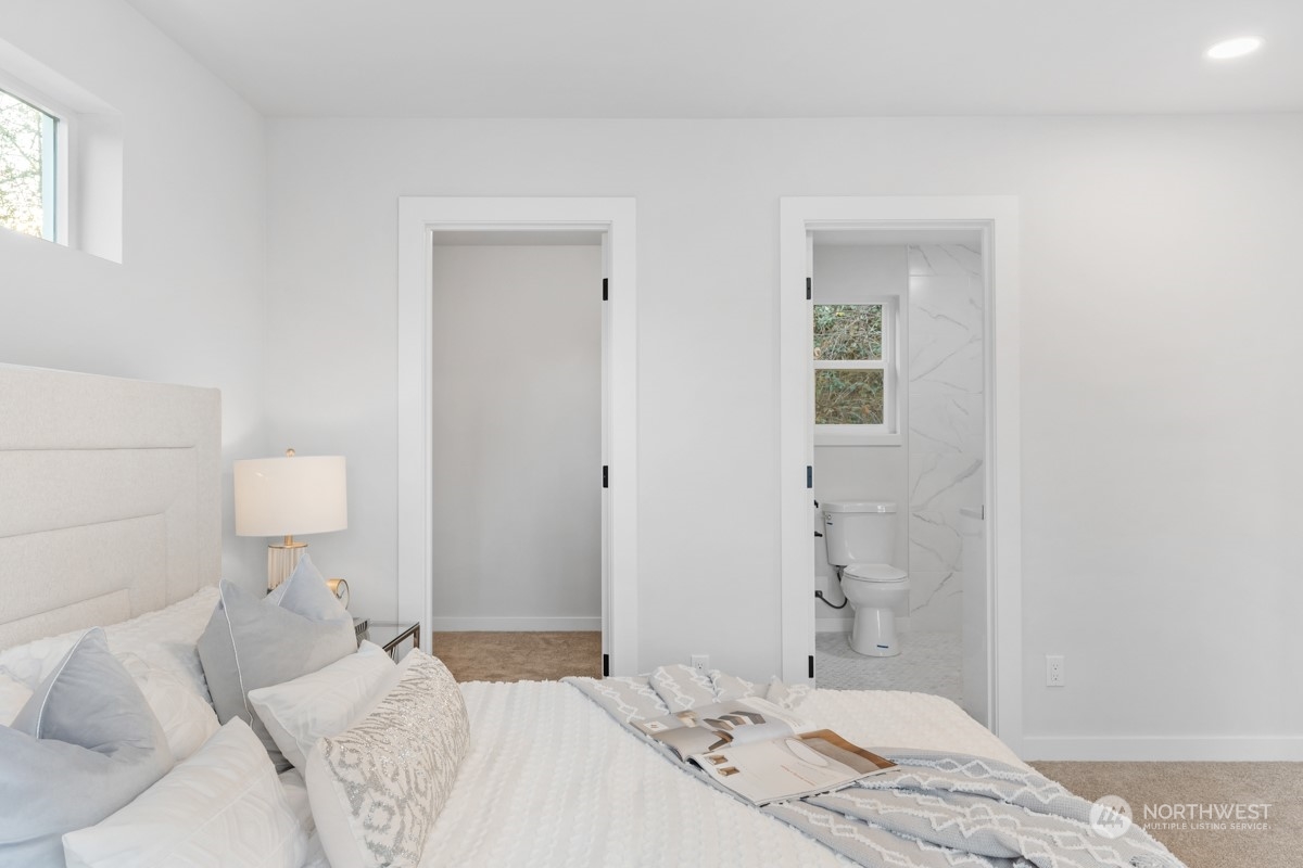 7511 Dumar Way Southwest Seattle, WA 98106 - Photo 20 of 35 a bedroom with a bed and a chair