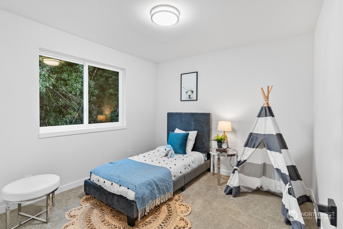 7511 Dumar Way Southwest Seattle, WA 98106 - Photo 25 of 35 a bedroom with a bed and wooden floor