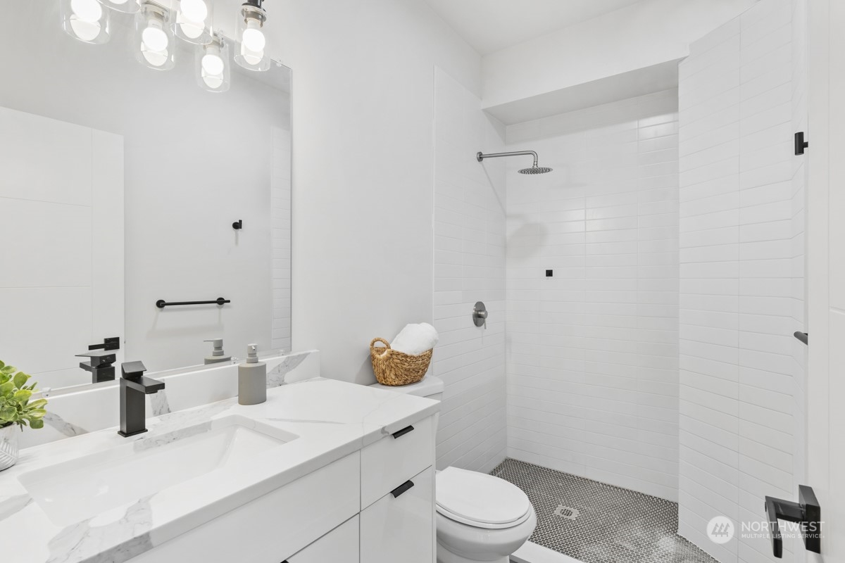 7511 Dumar Way Southwest Seattle, WA 98106 - Photo 31 of 35 a bathroom with a sink a toilet and shower