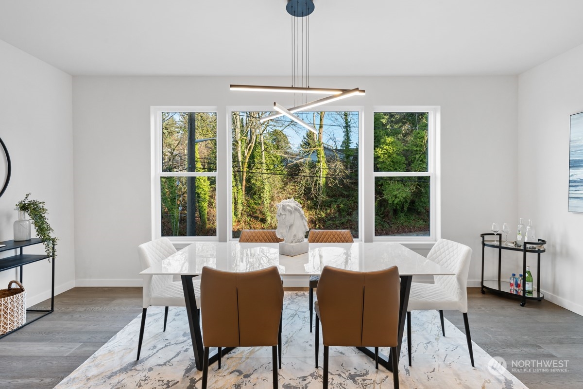 7511 Dumar Way Southwest Seattle, WA 98106 - Photo 9 of 35 a dining room with furniture and large windows