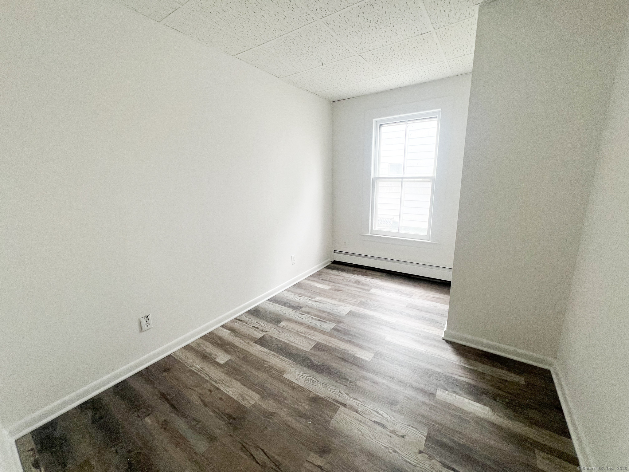 12 Blackall Road, Unit 1 Milford, CT 06460 - Photo 5 of 9 an empty room with wooden floor and windows