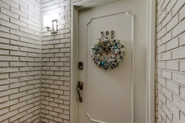 a view of a dining room with furniture and a chandelier