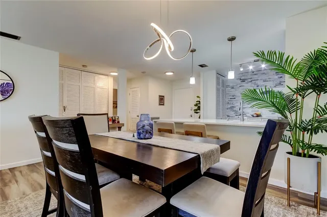 a view of a dining room with furniture and chandelier