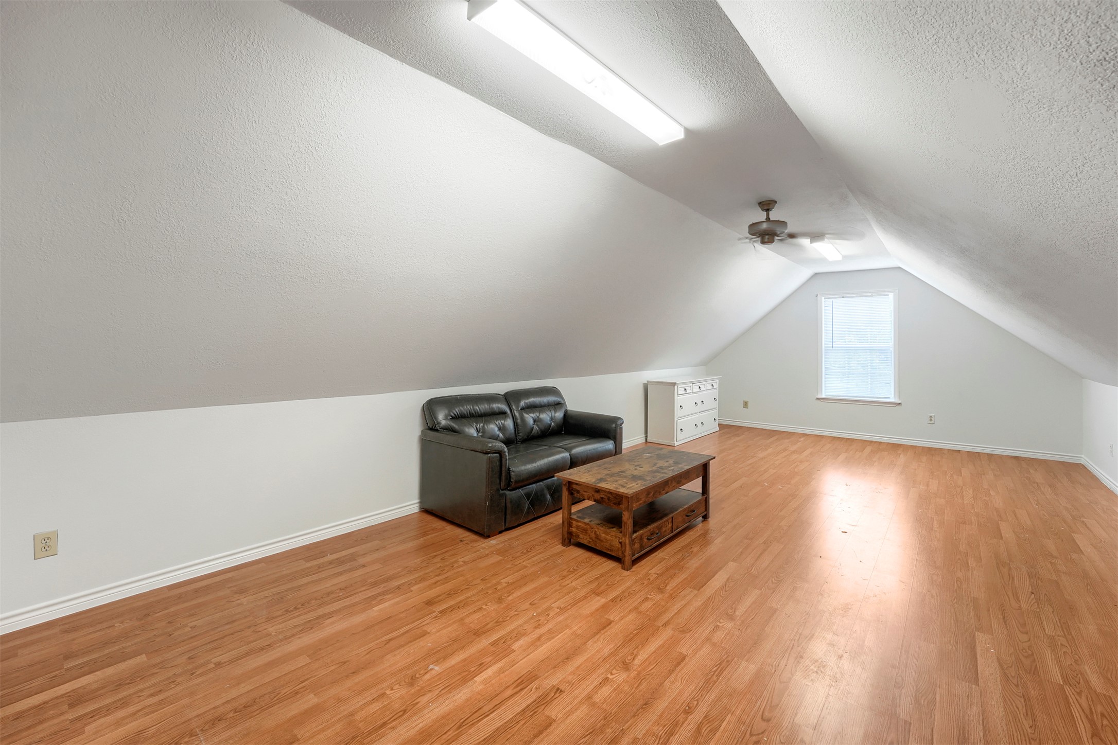 1105 2nd Street Jarrell, TX 76537 - Photo 20 of 27 Attic space with sloped ceilings and light wood floors offers versatile living.