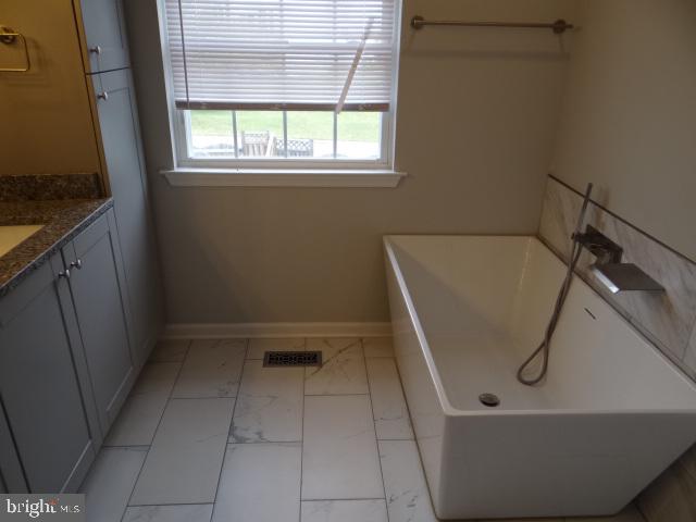 2246 Wetherburne Way Frederick, MD 21702 - Photo 13 of 23 Modern bathroom with sleek tub design.