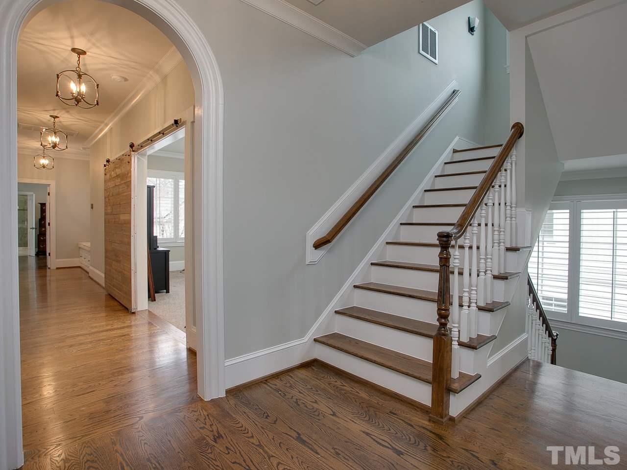 507 Guilford Circle Raleigh, NC 27608 - Photo 11 of 26 a view of a hallway with entryway wooden floor and front door