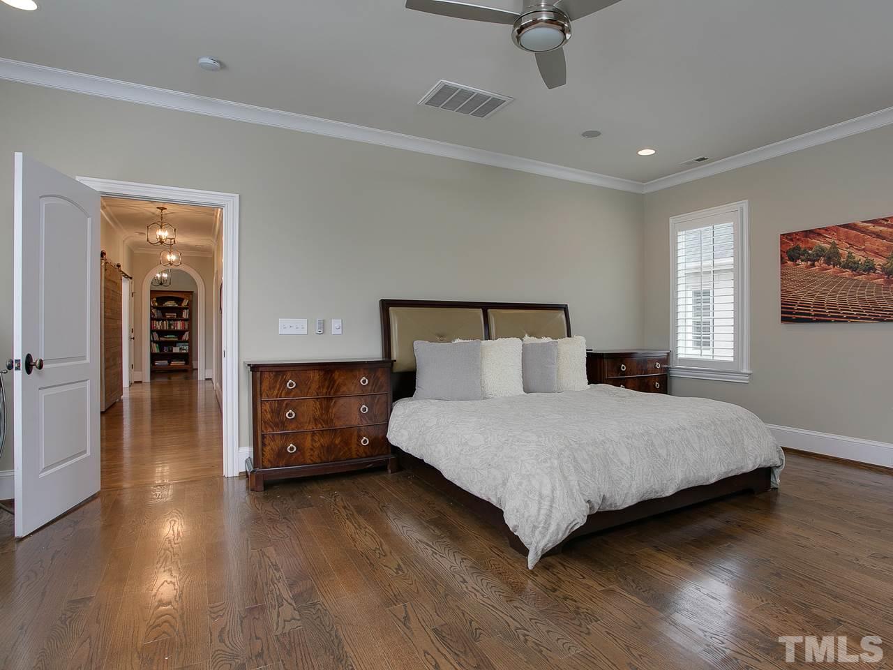 507 Guilford Circle Raleigh, NC 27608 - Photo 13 of 26 a spacious bedroom with a bed and a view of kitchen