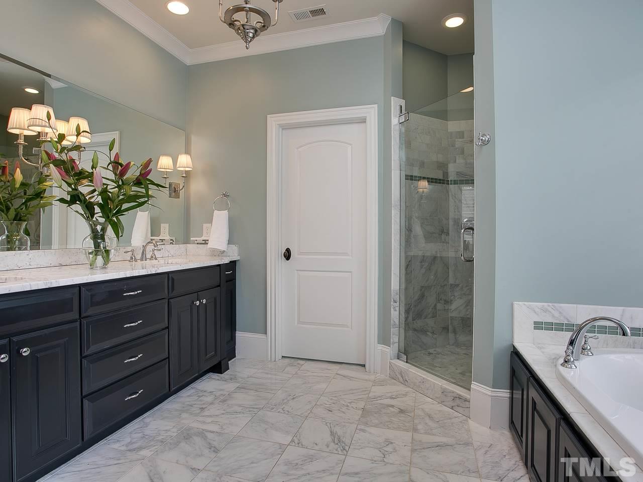 507 Guilford Circle Raleigh, NC 27608 - Photo 14 of 26 a spacious bathroom with a granite countertop sink a mirror and a shower