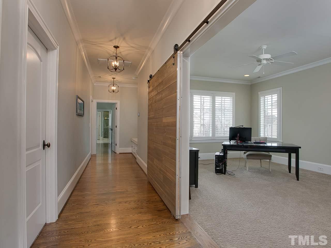 507 Guilford Circle Raleigh, NC 27608 - Photo 15 of 26 a hallway with a dining table wooden floor and a window
