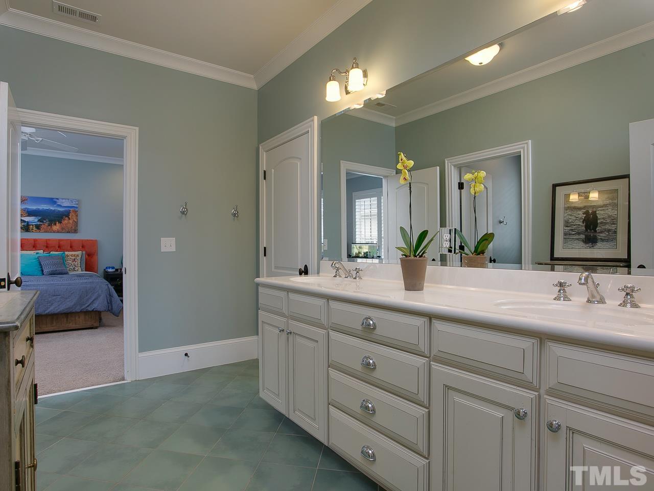 507 Guilford Circle Raleigh, NC 27608 - Photo 18 of 26 a spacious bathroom with a double vanity sink and a mirror