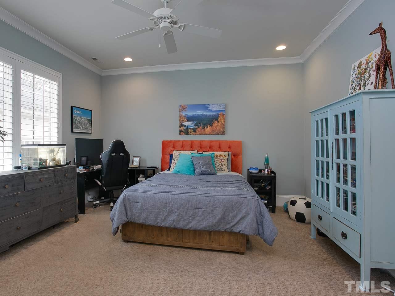 507 Guilford Circle Raleigh, NC 27608 - Photo 19 of 26 a spacious bedroom with a bed and a window