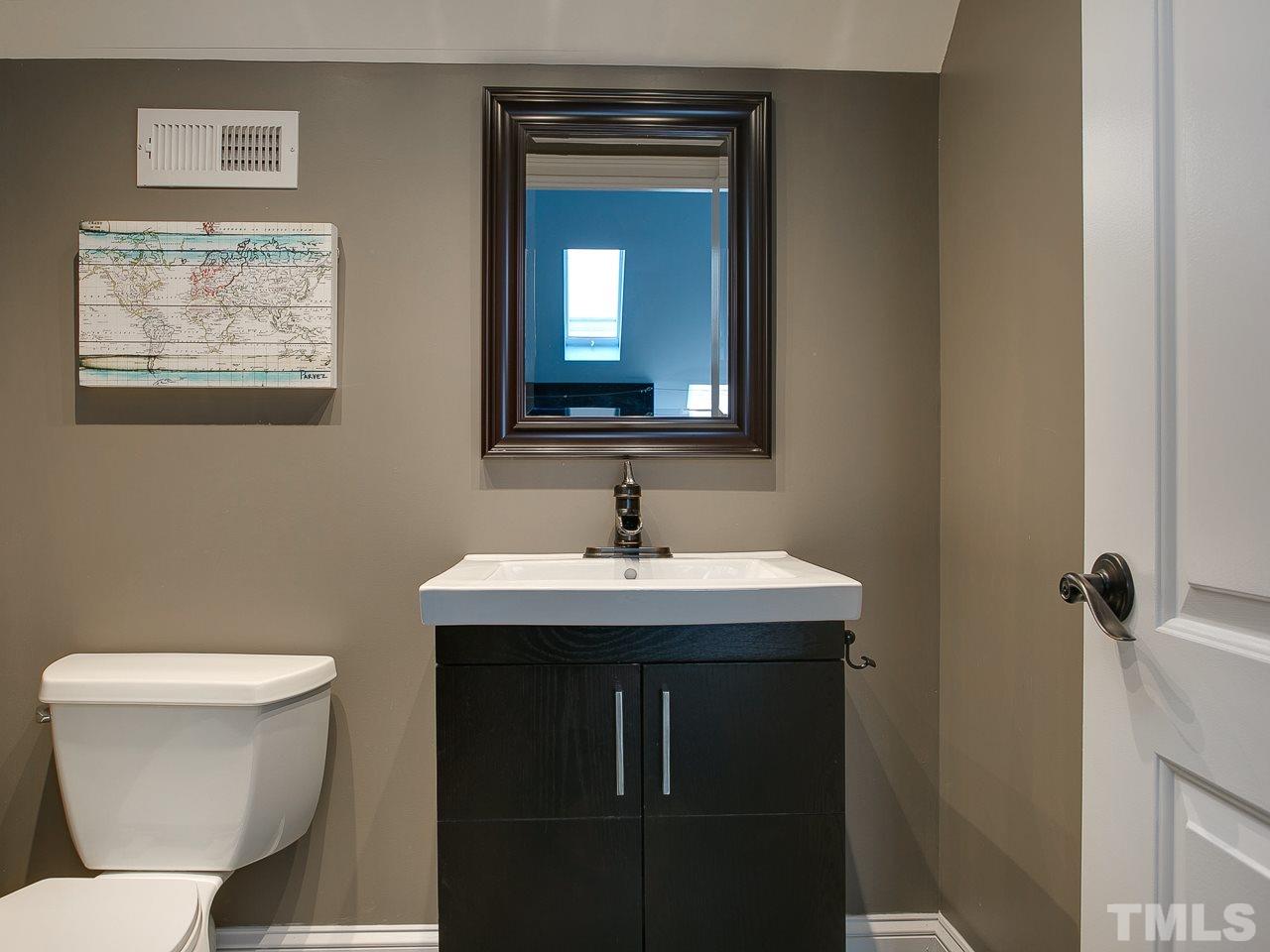507 Guilford Circle Raleigh, NC 27608 - Photo 21 of 26 a bathroom with a toilet sink and mirror