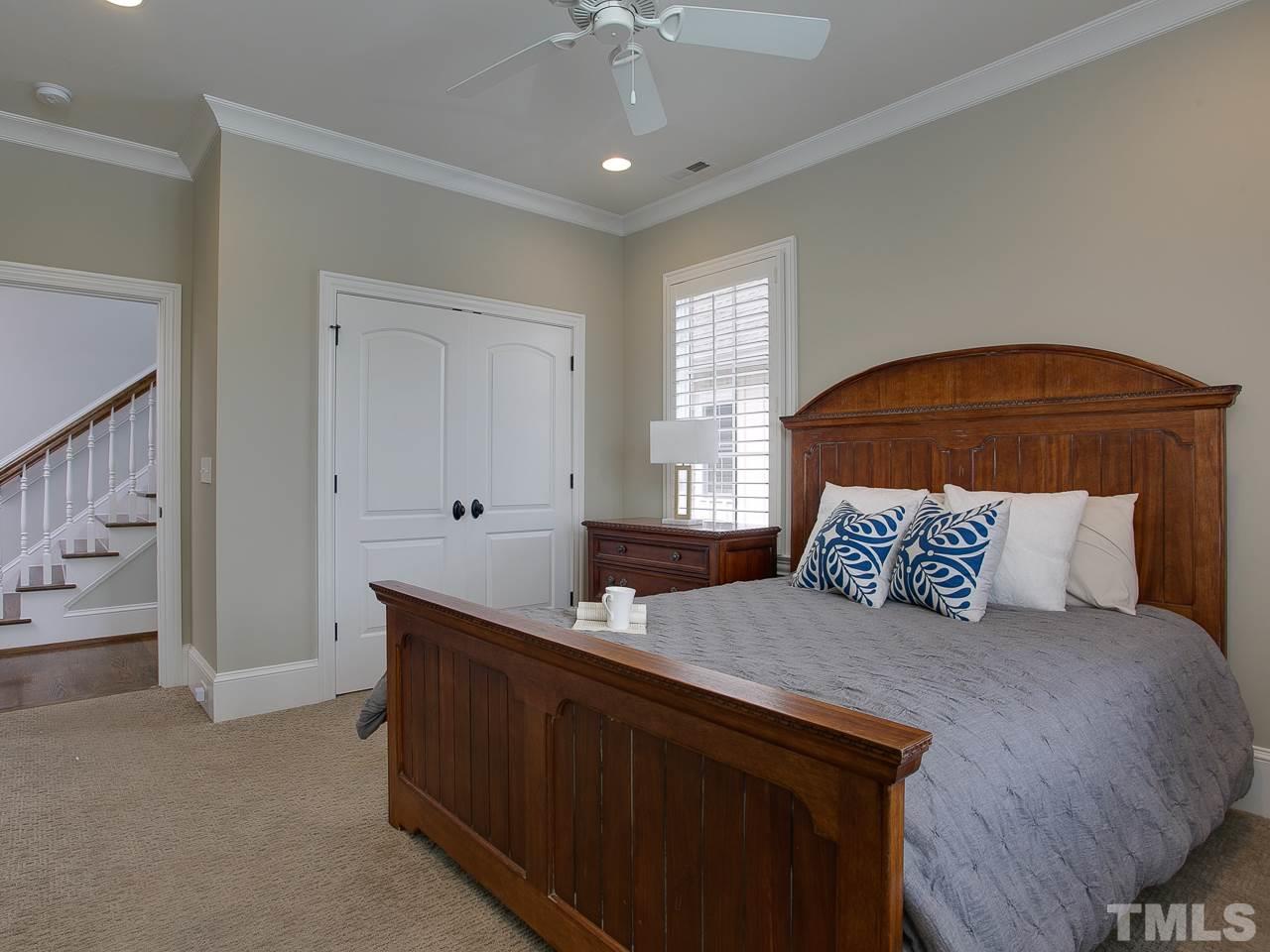 507 Guilford Circle Raleigh, NC 27608 - Photo 22 of 26 a bedroom with a large bed and a chandelier