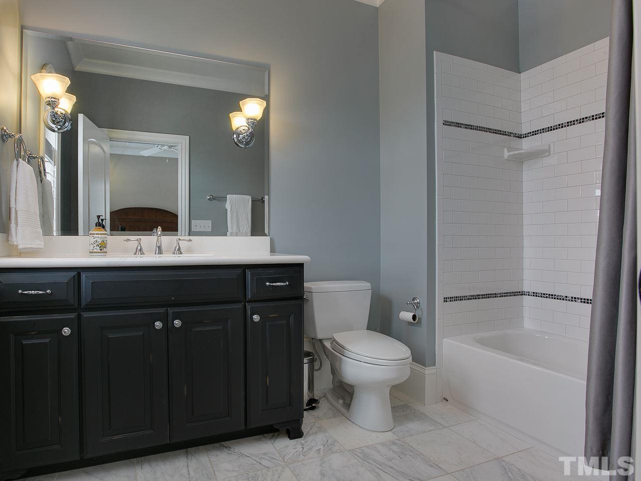 507 Guilford Circle Raleigh, NC 27608 - Photo 24 of 26 a bathroom with a bathtub shower sink vanity and toilet