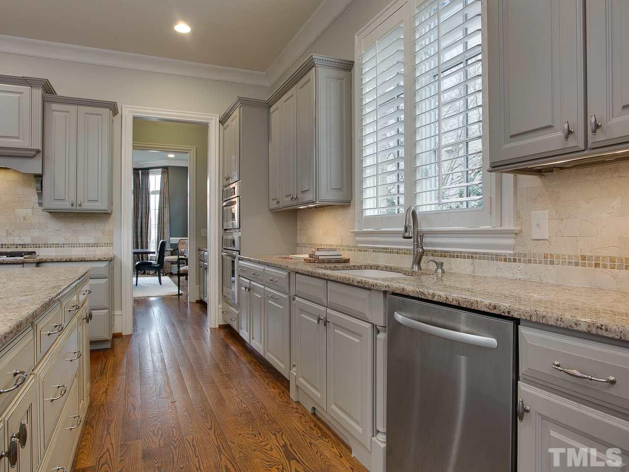507 Guilford Circle Raleigh, NC 27608 - Photo 6 of 26 a kitchen with granite countertop a sink a counter space appliances and cabinets