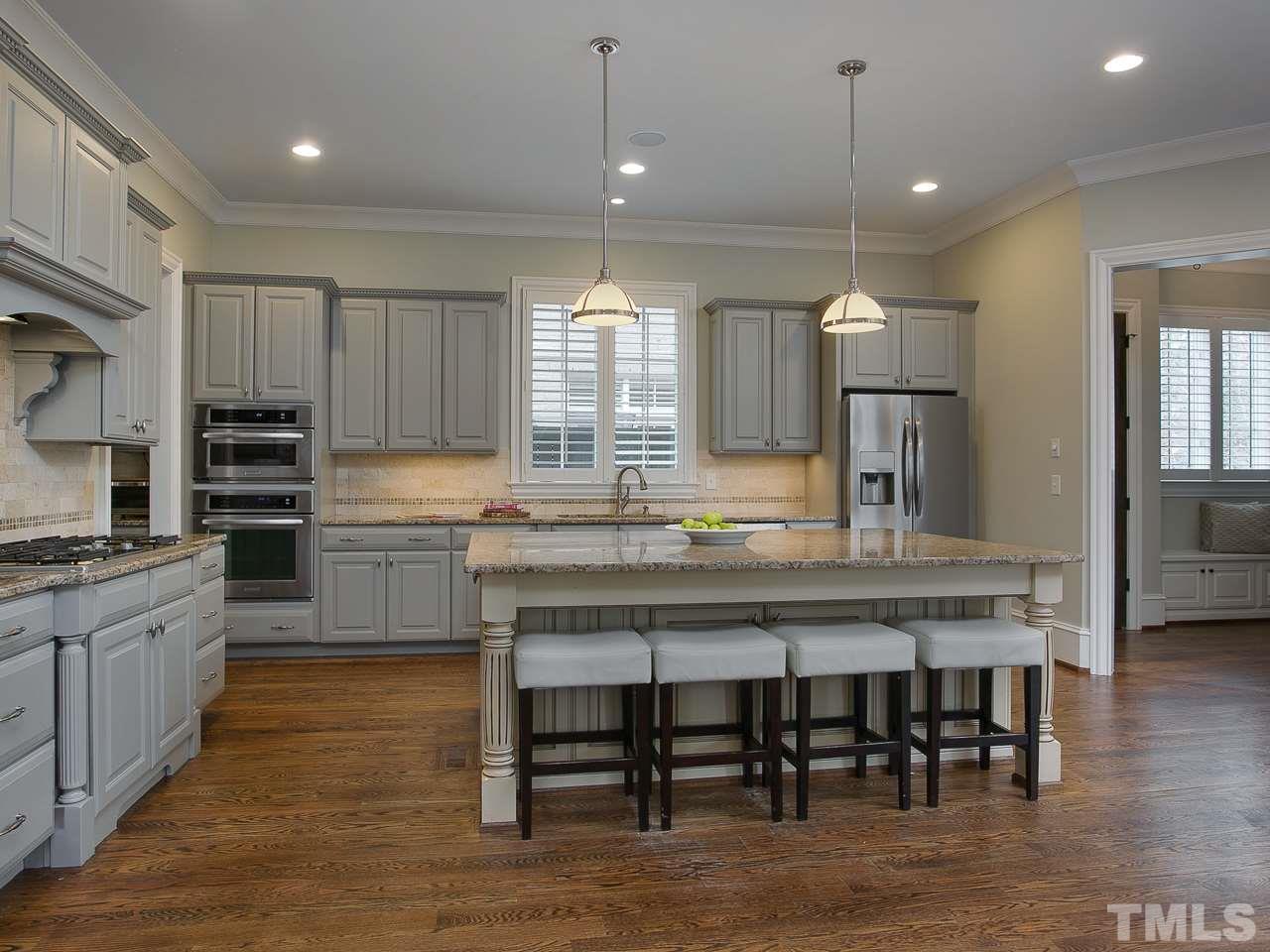 507 Guilford Circle Raleigh, NC 27608 - Photo 7 of 26 a large kitchen with kitchen island a island a sink a stove and a center island