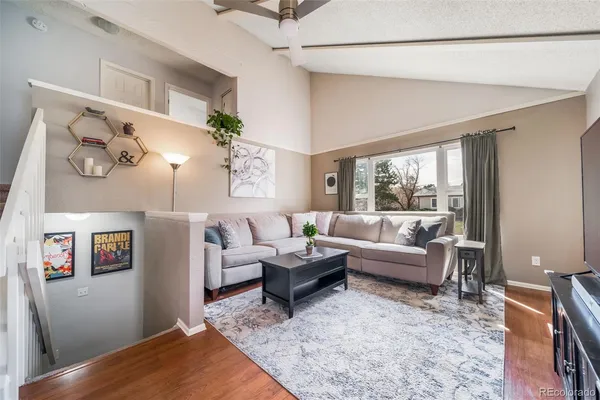 a living room with furniture and wooden floor
