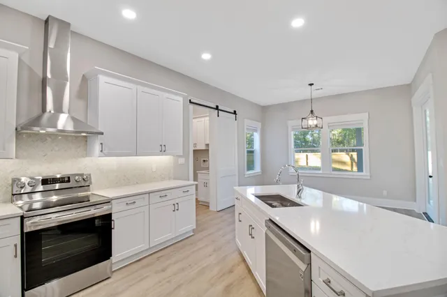 a kitchen with a sink stove and microwave